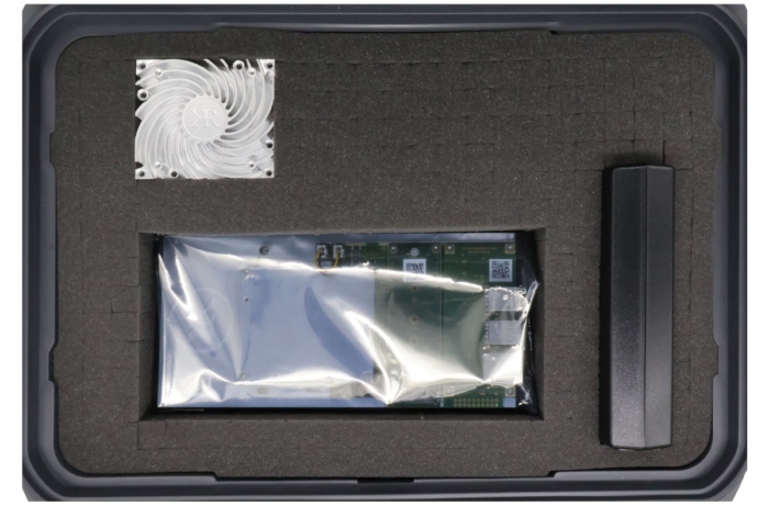 KRC-2000 evaluation carrier with KRM-4 RFSoC FPGA module in ESD bag, heat sink, and power source in shipping case.